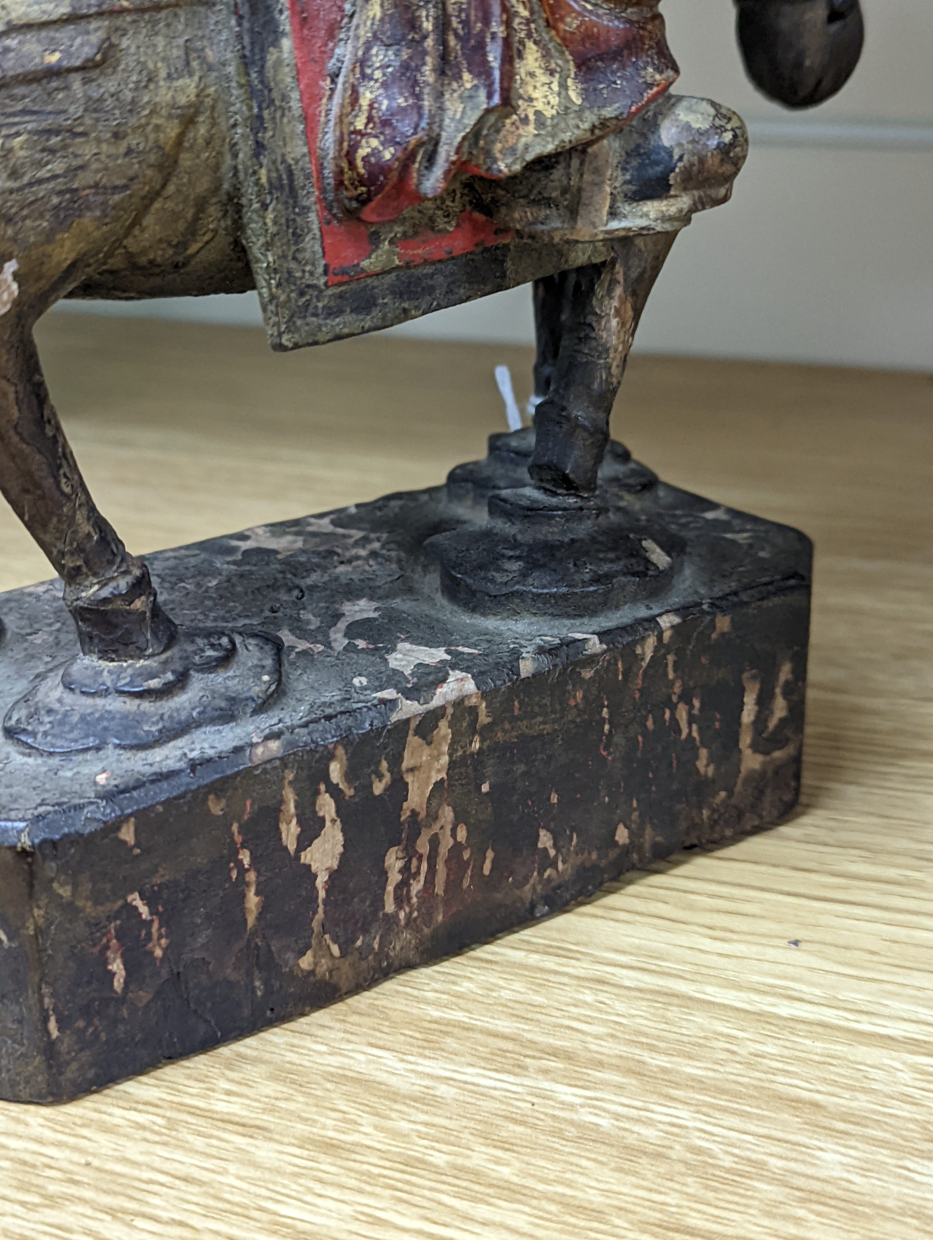 An 18th/19th century Chinese lacquered wood group of an official riding a horse, 30cm